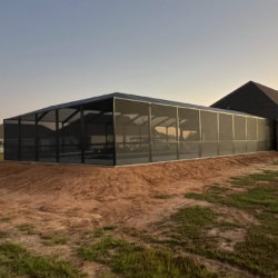 Screened pool enclosure around backyard pool