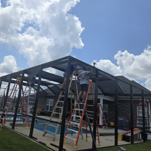 Our crew building a pool enclosure